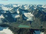 Several retreating unnamed, small valley glaciers and several recently deglacierized cirques and ridges north of the terminus of Tonsina Glacier, northcentral Chugach Mountains, Alaska. Much of the ice disappeared during the last few decades of the twentieth century. Note the fresh moraine deposits. Photograph by Bruce F. Molnia, USGS.