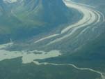 South view of the terminius of the thinning and retreating Schwan Glaciers located south of the Tasnuna River and west of the Copper River, northcentral Chugach Mountains, Alaska. Note the ice-marginal lake that has developed in front of the retreating terminus.Much of the terminus is debris-covered. Photograph by Bruce F. Molnia, USGS.