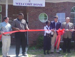 Alma Tilley cuts the ribbon on her new home in Tyler, TX.