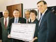 VA Secretary Principi, HHS Secretary Thompson, ICH Director Mangano, CSB Director Poppe, and HUD Secretary Martinez with a check for $75 Million.