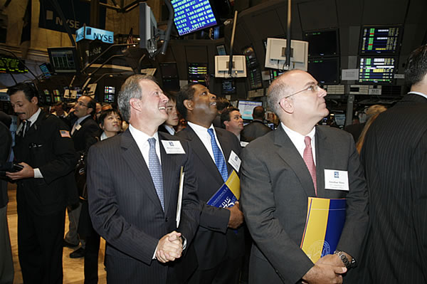 FDIC Road Show event panelists Richard Neiman, Derrick Cephas and Jonathan Mintz view the Opening Bell from the floor of the New York Stock Exchange. 