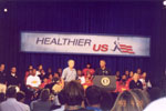 People listening as Lynn Swann introduces the President at the HealthierUS event in Dallas, Texas.
