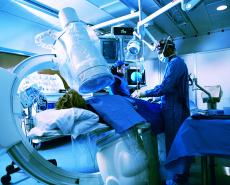 Fotografía de un doctor y un tecnólogo realizando una angiografía