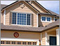 Close-up photo of the exterior of a two-story, wood house.