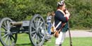 A park volunteer, dressed as an American soldier, helps orient visitors to what they are seeing.