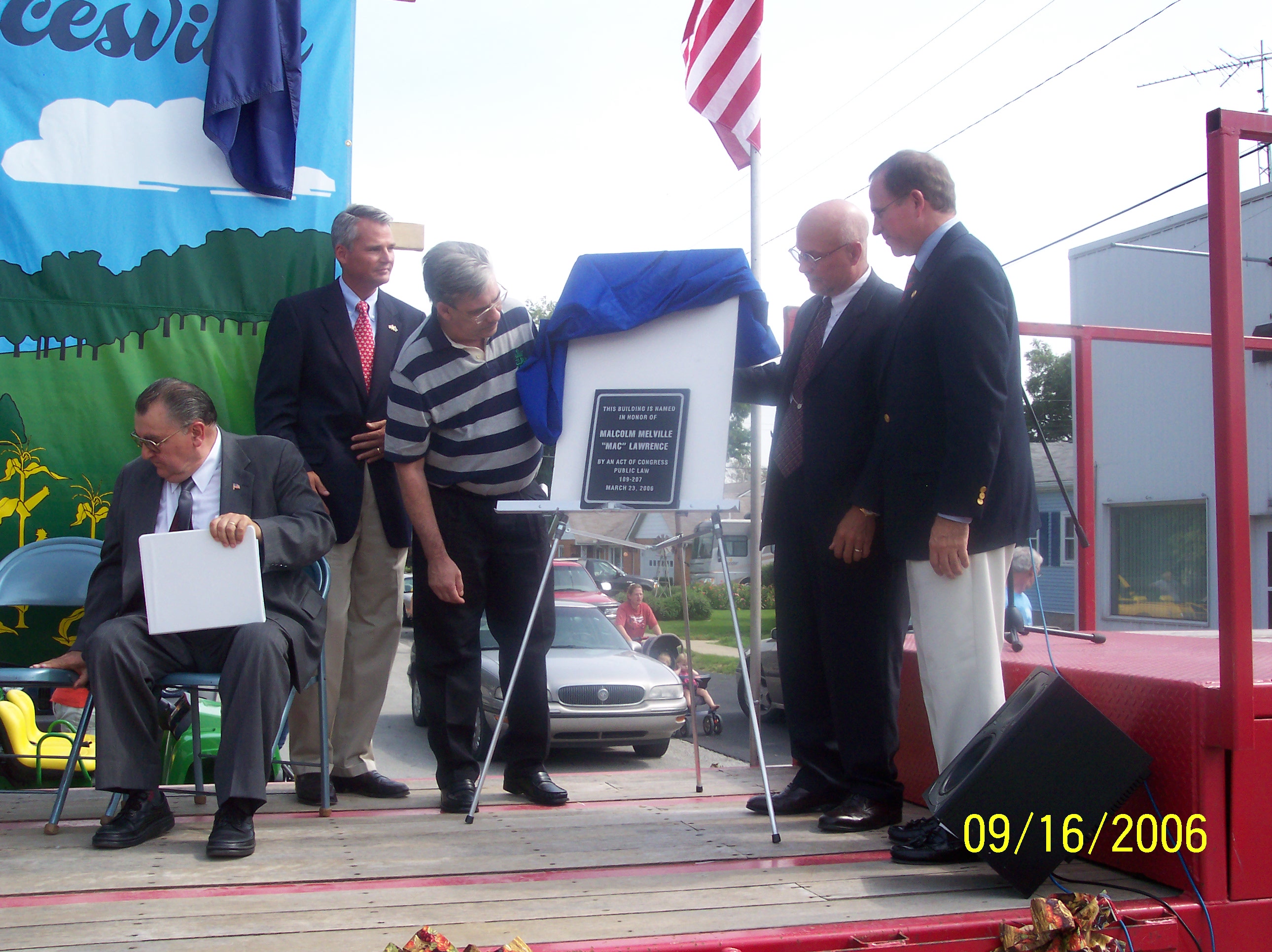 (Pictured L to R ) Rev. Laszle Kovacs, Congrressman Chocola, Jack Lawrence (Mac's son), David Light (Post Office Operations Manager) and Congresman Steve Buyer unveiling the plaque naming the Mac Lawrence Post Office by an act of Congress