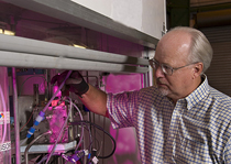 Dr. Bill Summers with the single-cell version of the laboratory's unique electrolyzer