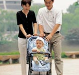 Parents pushing baby in stroller