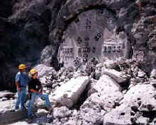 The cutter head of the tunnel boring machine shoves through the rocky face of Yucca Mountain to daylight