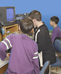 Middle school boys learning to use audio visual equipment