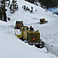 heavy equipment operators move snow in Sylvan Pass
