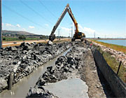 photo: Cutoff wall trench filling with cement-bentonite slurry