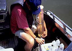 Chemist Norbert Cannon, PN Regional Soil and Water Laboratory, Boise, Idaho, collecting water samples for chemical analyses using a Kemmerer bottle at Lake Owyhee, Oregon.