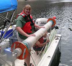 Biologist Sue Camp of the Montana Area Office with a vertical gill net mounted on the 23-ft Parker cabin cruiser on Bighorn Lake in Montana.