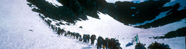 line of modern hikers on snowy slope of Chilkoot Trail Photo credit: J Eve Griffin