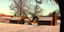 Reconstructed soldier cabins in the winter with snow on the ground