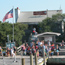 Group of people stand nears stairs to small visitor contact station.