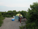 Camper at grill in Watch Hill Campground.