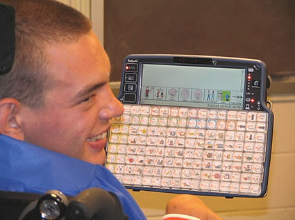 An individual showing off his communication device and smiling.