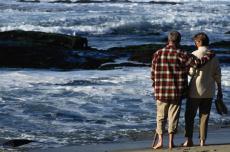 Photograph of a man and woman walking on the beach