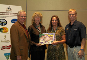 Photograph:  Donna Bayless Ray poses with award.