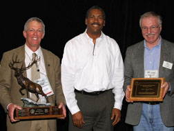 Photograph: Hank Kashdan (USFS/Associate Chief/Operations ;left - holding elk statue), Randy Moore (USFS/PSW Regional Forester; center) and Jack Blackwell (RMEF/Vice President of Lands and Conservation; right - holding plaque).
