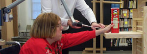 Image of a female in a wheelchair participating in a reach experiment 