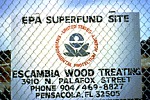 Sign behind a fence informing visitors of the Superfund work in action.