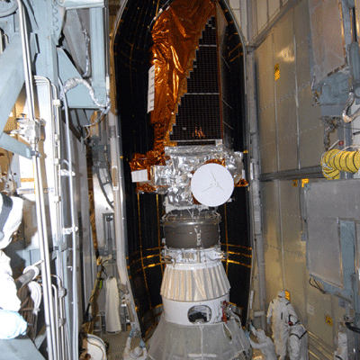  Workers attach the two-part payload fairing over the Kepler spacecraft in preparation for launch.