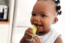 Image of a baby eating an apple