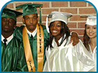 Four Students in Graduation Cap and Gown