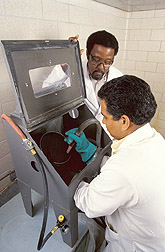 Photo: Chemist Charles James (left) and food technologist Harmeet Guraya conduct a flourblasting test on long-grain brown rice. 