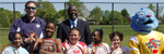 Click to enlarge a photo of Dr. Garth Graham poses for a photo with DEUCE participants and the USDA Power Panther