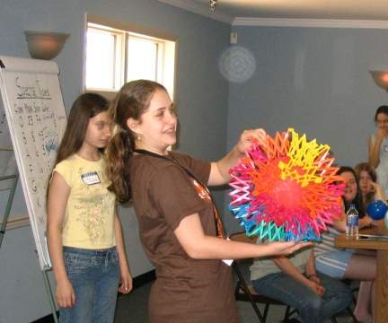 Picture of a Girl Scout helping to demonstrate what happens 
		in a supernova explosion, as described in the activities section of this web site