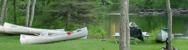 Canoes pulled up at campsite after finishing paddling for the day