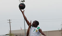 Photo of Athletes participating in a pickup game with members of the local community