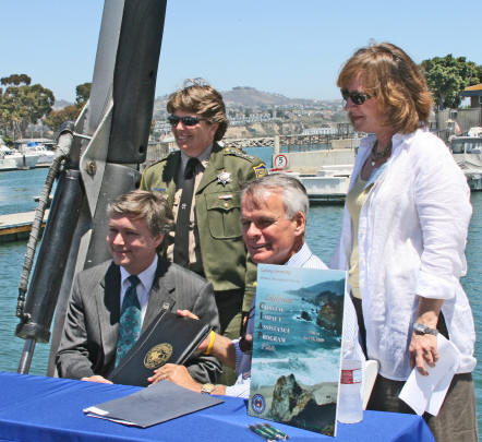 From left to right, MMS Acting Director Dr. Walter Cruickshank, California Fish and Game Chief of Enforcement Nancy Foley, California Secretary of Natural Resources Mike Chrisman, and MMS Pacific Regional Director Ellen Aronson commemorated MMS's July 13, 2009, approval of California's Coastal Impact Assistance Program Plan in Dana Point Harbor onboard a state marine patrol boat that is slated to be refurbished with CIAP grant funds.