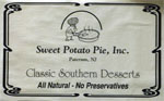 Sign reading 'Sweet Potato Pie, Inc., Paterson, NJ, Classic Southern Desserts, All Natural - No Preservatives'