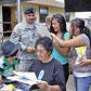 Lt. Col. Adrian Nagel, garrison commander of Camp Navajo, Ariz., and members of the Elfrieda Etsitty Tsosie Family, examine historical documents at the Camp Navajo Reunion July 19, 2007.