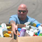 Staff Sgt. Michael Moore, of the 4th Infantry Division, Fort Hood, Texas, disposes of two boxes full of hazardous household products during a household hazardous and bulk recyclable material turn-in event on Fort Hood.
