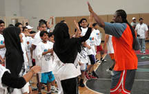 Photo of Andrea giving hearty high-fives to participants