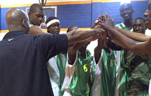 Photo of Sports Visitor participants from Mali huddled together on the basketball court.