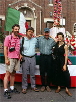 Four fieldworkers posing in front of a church