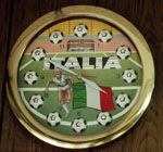 A clock with a soccer scene on its face