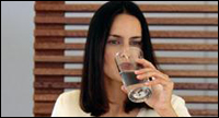 Photo: A woman drinking a glass of water.