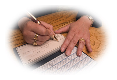 Photo of a woman writing a check.