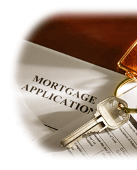 Photo of house keys on top of a mortgage application.