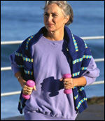 Photo: A woman walking with weights.