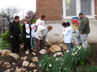 IMLS Director Anne Radice joins Stuart-Hobson Middle School students to bury a time capsule in honor of the school's new archives.