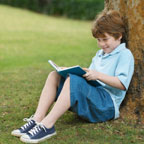 A boy is reading a book.